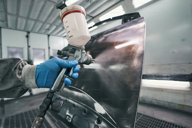 Car body panel being resprayed in a paint booth
