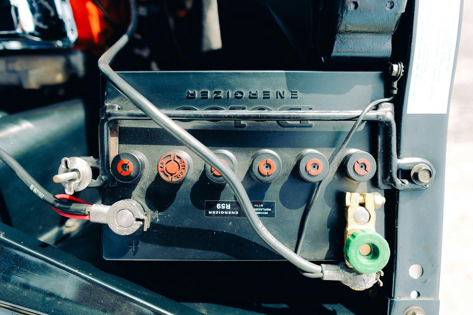 Battery terminal clamp being tightened during a replacement