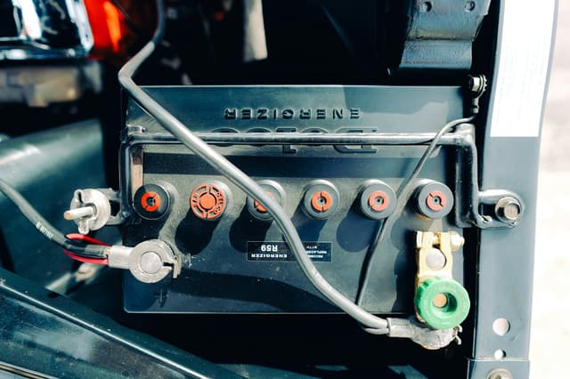 Battery terminal clamp being tightened during a replacement
