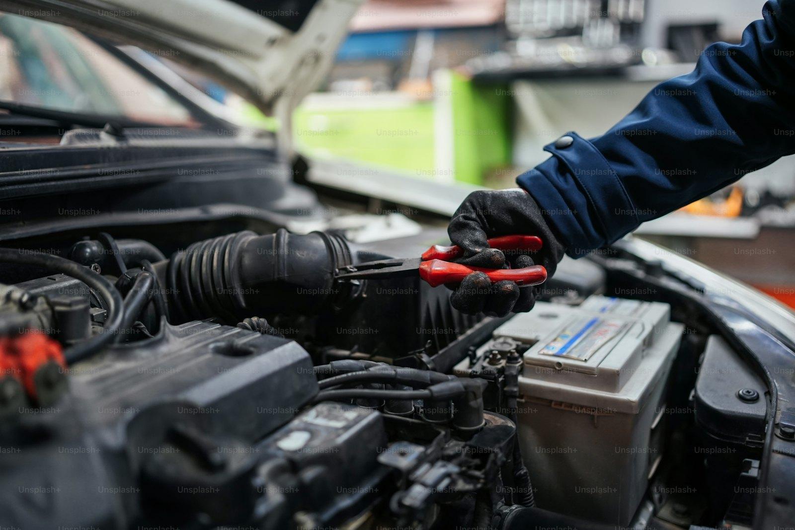 Technician working on a car engine during a service