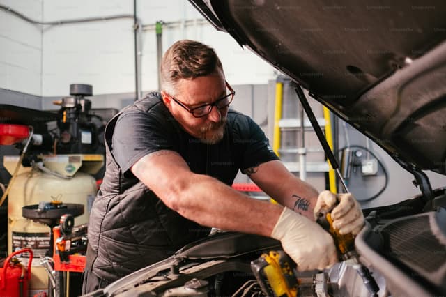 Car mechanic in a workshop, tools in hand